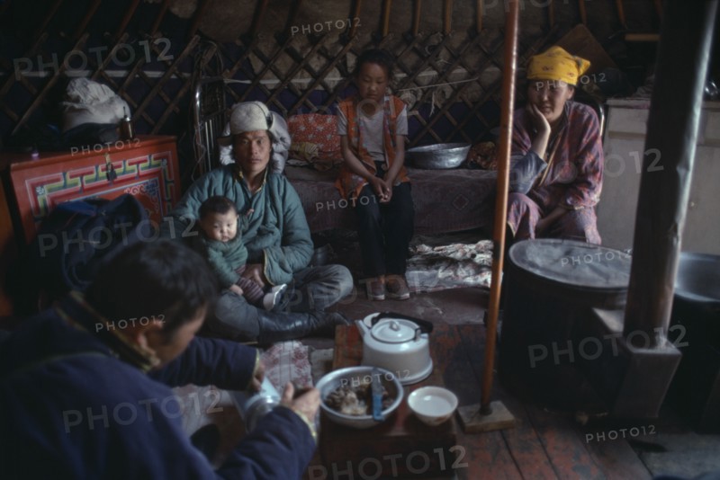 MONGOLIA, People, Mongolian family having meal inside a yurt