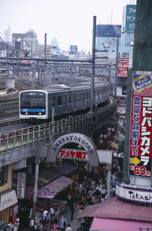 JAPAN, Honshu, Tokyo, View over the busy Ameyayokocho market street and the elevated train tracks above