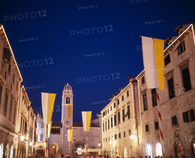CROATIA, Dalmatia, Dubrovnik, View along the Stradun toward the clocktower with Vatican flags for the papal visit June 2003