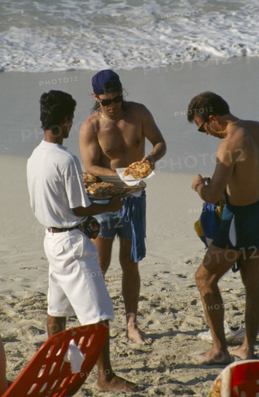 CUBA, Matanzas Province, Varadero, Man selling pizza to tourists on the beach