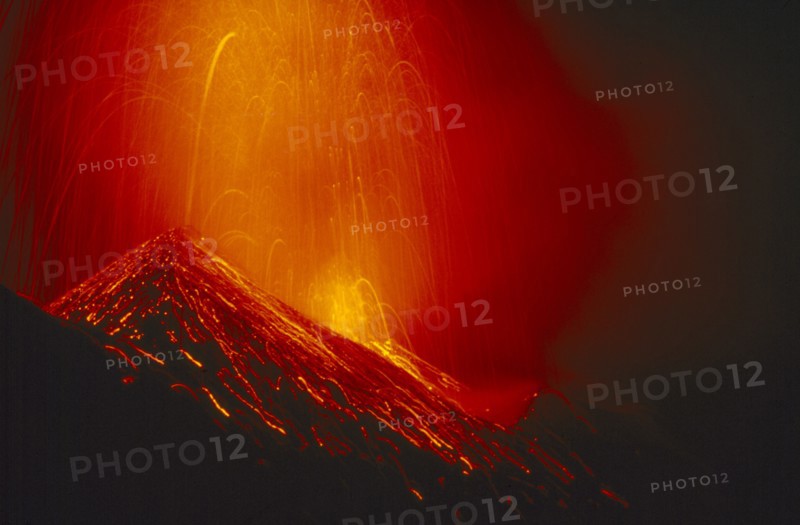 ITALY, Sicily, Volcano Stromboli erupting at night.
