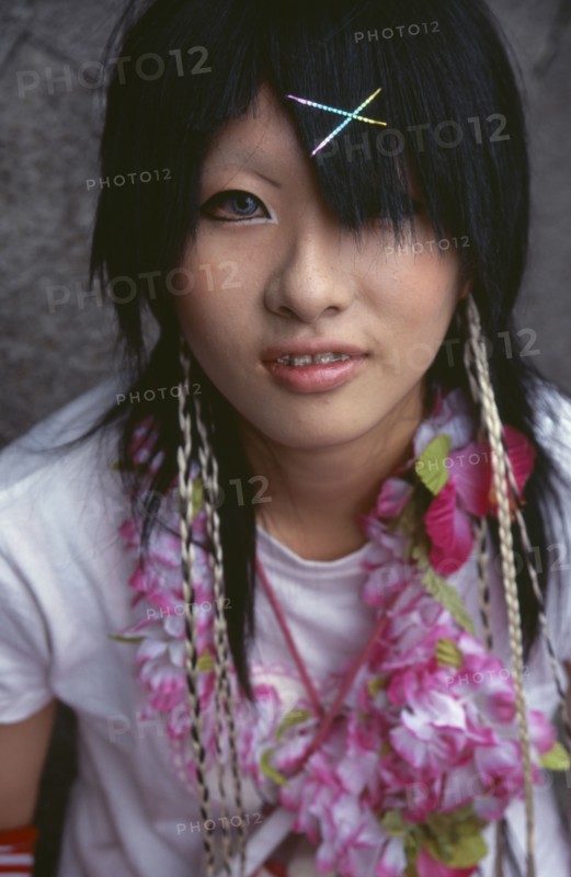 JAPAN, Honshu, Tokyo, Harajuku District. Portrait of a teenage girl wearing a flower garland and sparkling hairclips