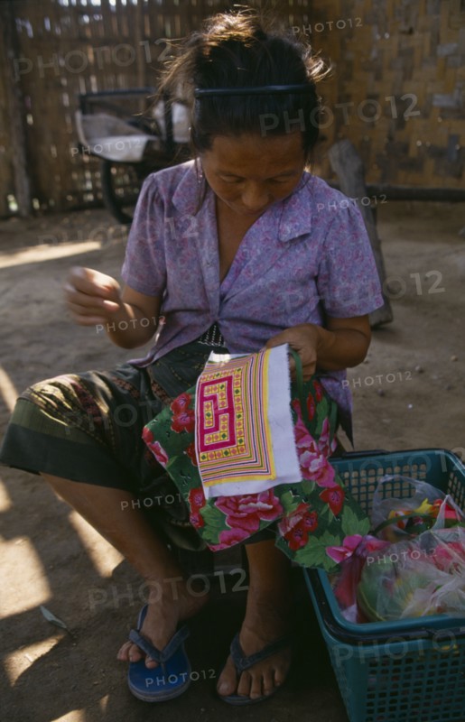 LAOS, Craft, Hmong woman embroidering textile