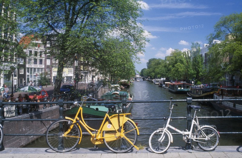 HOLLAND, Noord, Amsterdam, Bicycles leaning against the railings of a bridge over the Keizersgracht canal