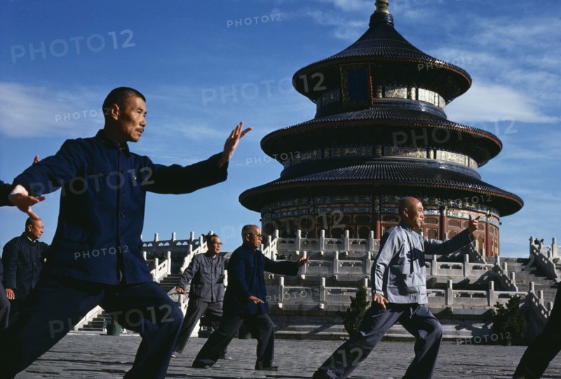 CHINA, Hebei, Beijing, Group of men practising Tai Chi in front of the Temple of Heaven.