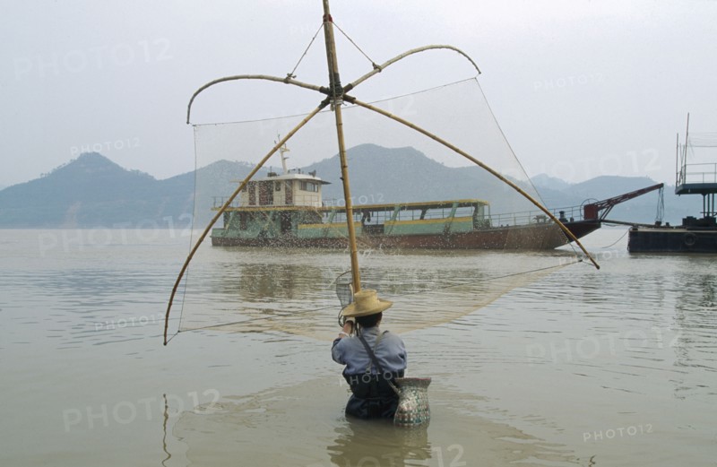 CHINA, Hubei Province, Yichang, Man fishing in the Yangtze River
