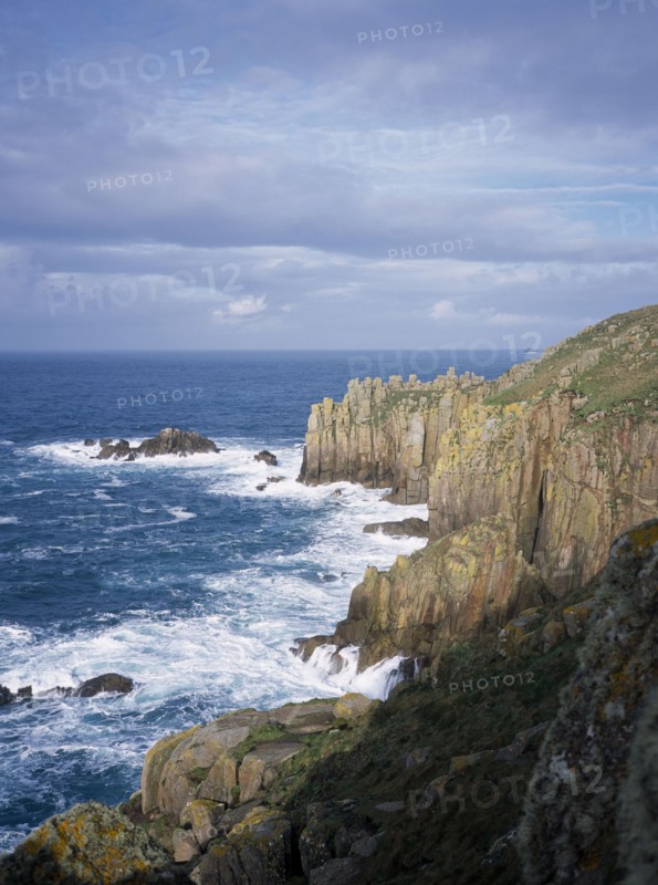 ENGLAND, Cornwall, Lands End, Waves breaking against eroded sea cliffs in winter.