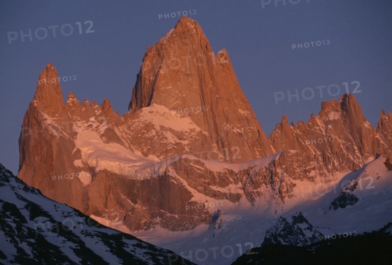 ARGENTINA, Patagonia, Santa Cruz, "Parque Nacional Los Glaciares, Monte Fitz Roy.  Snow lying on peaks and ridges in golden light."