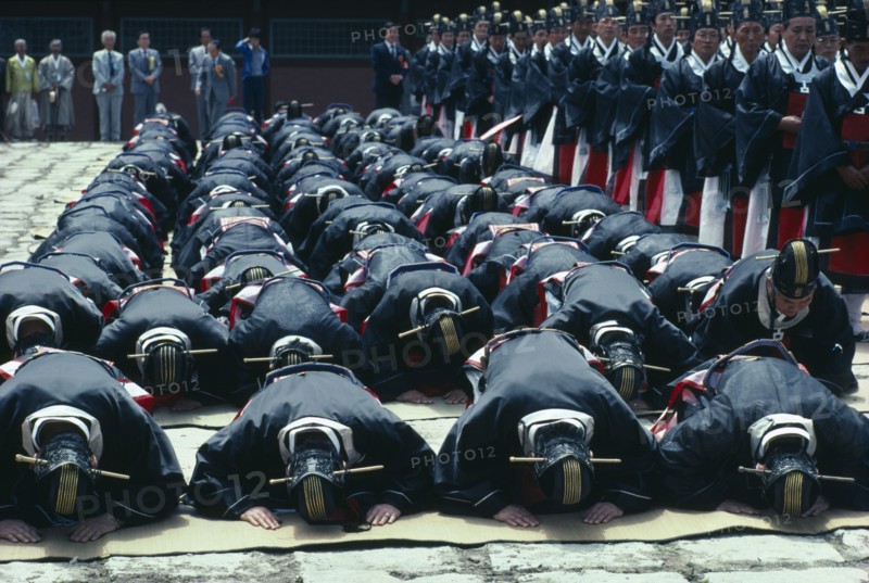 SOUTH KOREA, Seoul, Ching Myo Temple Confucian rites ceremony with worshippers prostrating to the ground.