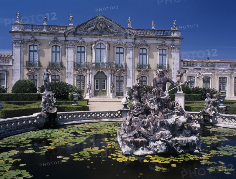PORTUGAL, Near Lisbon, Palacio Nacional de Queluz facade with pond and central statue in the foreground.