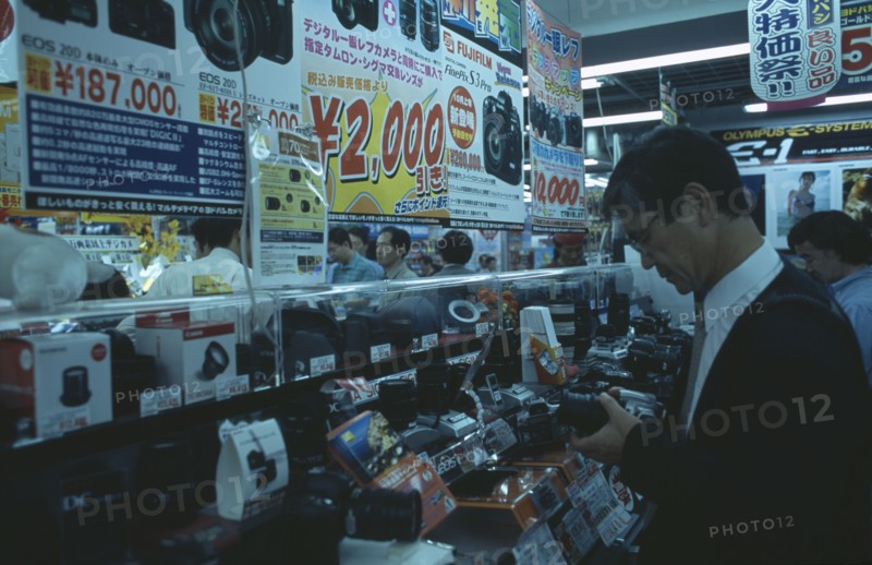 JAPAN, Honshu, Tokyo, Shinjuku. Customers browsing in busy Camera shop interior