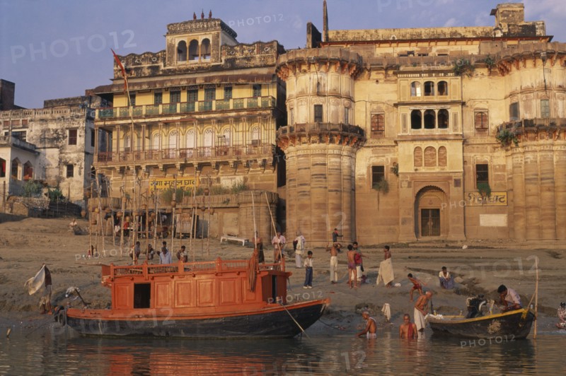 INDIA, Uttar Pradesh, Varanasi, Boats and ritual bathers on the ghats at dawn.