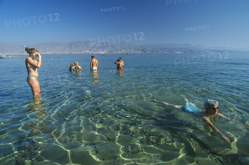 ISRAEL, Eilat, Coral Beach.  Swimmers on Red Sea coast resort.