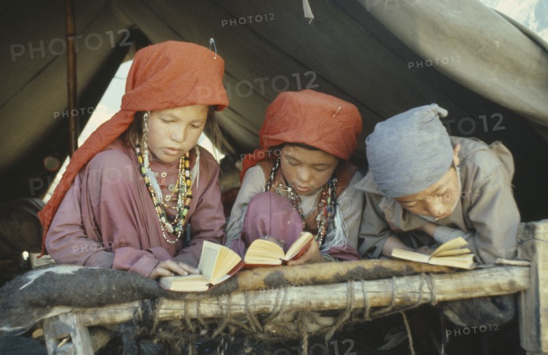 AFGHANISTAN, Children, Kirghiz children studying the Koran.