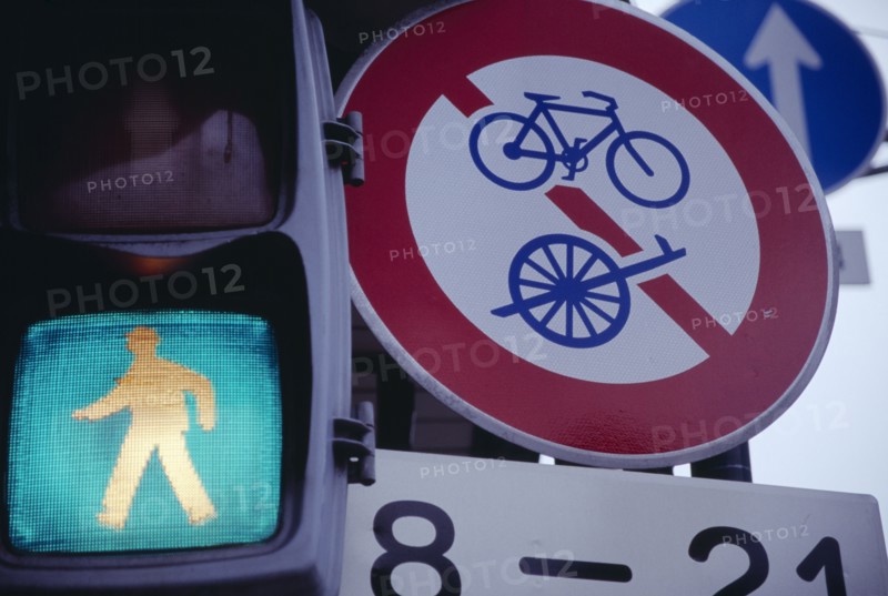 JAPAN, Honshu, Kyoto, Green light of a pedestrian crossing next to bicycle road signs