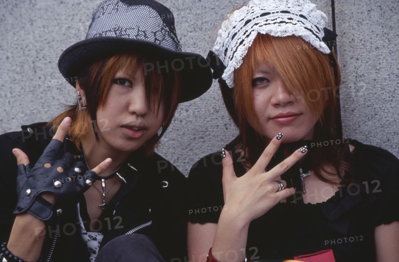 JAPAN, Honshu, Tokyo, Harajuku District. Portrait of two girls dressed in teenage Japanese style