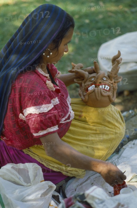 MEXICO, Festivals, Woman making clay figure for Day of the Dead.