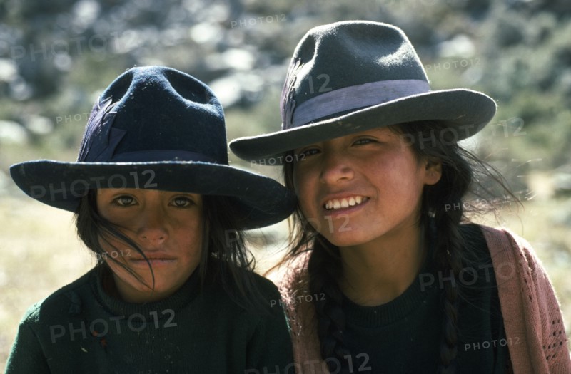 PERU, Ancash, Cordillera Blanca, Head and shoulders portrait of two girls from Quebrada Quilcayhuanca.