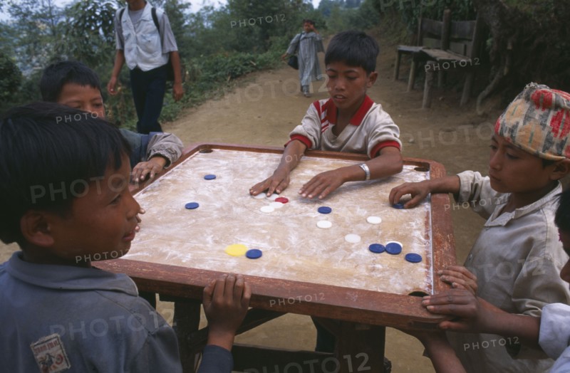 NEPAL, Dhankuta Region, Children, Limbu boys playing Karem board game.