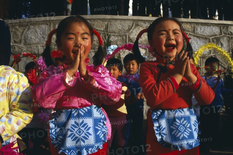CHINA, Yunnan Province, Tribal People, Two small girls performing song.