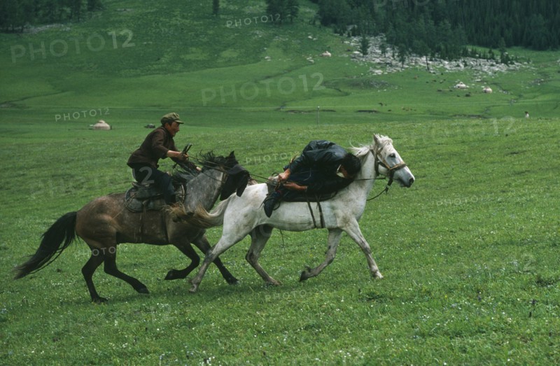 CHINA, Xinjiang Province, Traditions, Kazakh traditional wrestling on horseback called Audaryspak performed at weddings and festivals.
