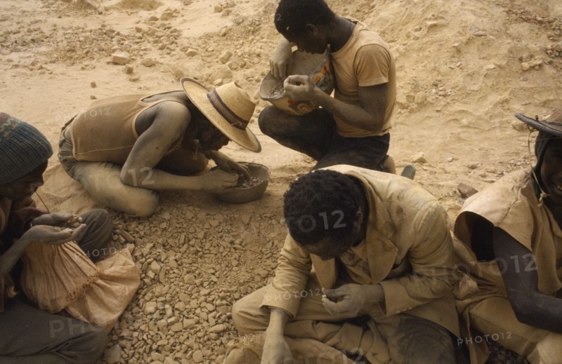 BURKINA FASO, Sahel, Dust covered group of gold miners.