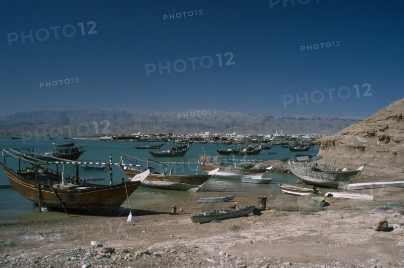 OMAN, Sur, Boats moored along coastline.