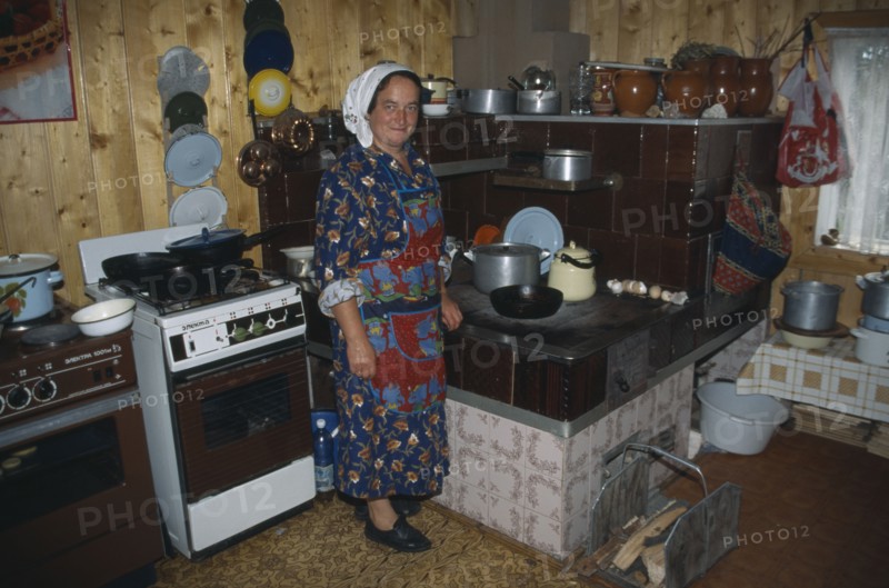 UKRAINE, Carpathian Mountains, Hutsul woman in kitchen.