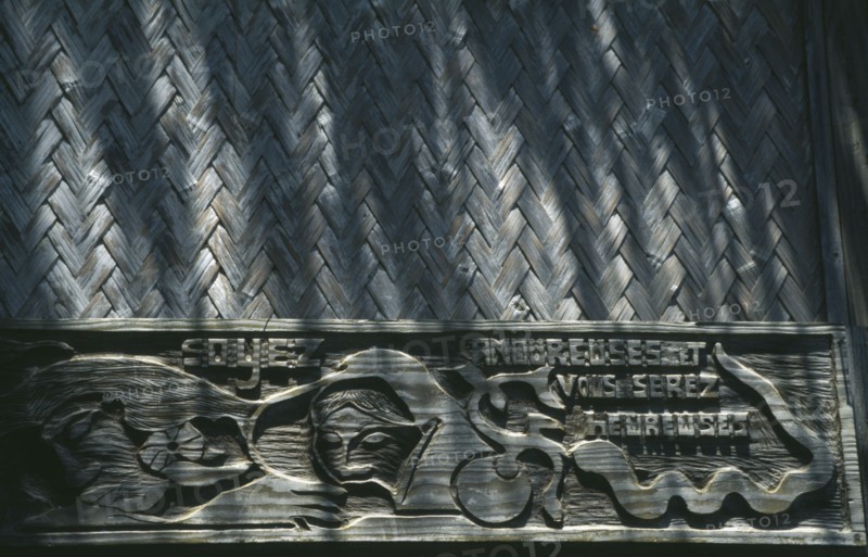PACIFIC ISLANDS, Polynesia, French Polynesia, Marquesas.  Hiva Oa.  Carved wooden inscription on house where the artist Paul Gaugin lived.