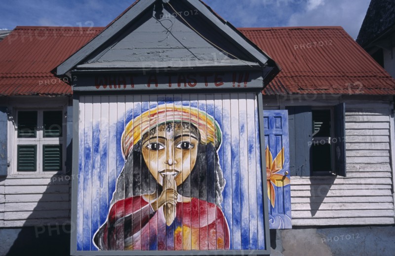 WEST INDIES, Windward Islands, Dominica, Roseau.  Mural on exterior of bread shop in the centre of the capital.