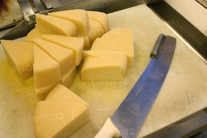 USA, Minnesota, St Paul, "Wedges of freshly cut Park brand Parmesan Cheese from Wisconsin at the Mississippi Market a natural foods co-op located at Dale and Selby, waiting to be wrapped, weighed and packaged."