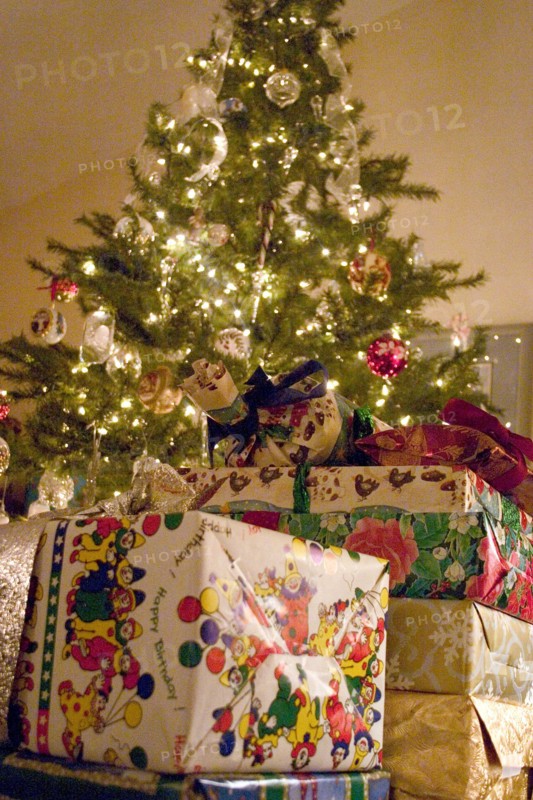 USA, Minnesota, Brooklyn Center, Christmas presents piled high around the decorated evergreen tree.