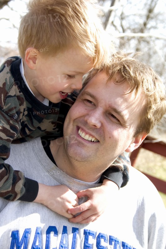 USA, Minnesota, Clitherall, Son talking to dad with arms around his neck.