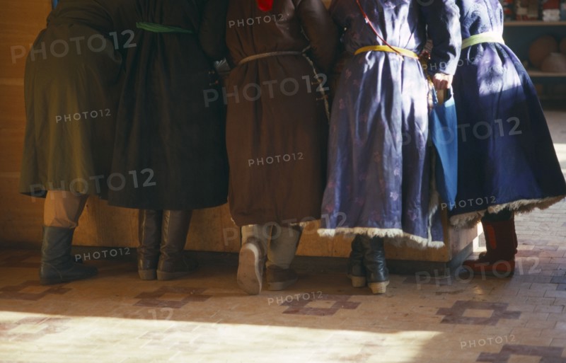 MONGOLIA, People, Cropped view of group of women standing at counter of shop.