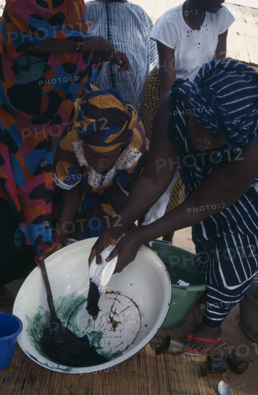 GAMBIA, Work, Women tie dye fabric.