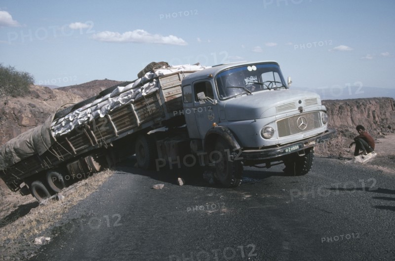 ETHIOPIA, Transport, World Food Programme lorry with trailer having slipped off the road
