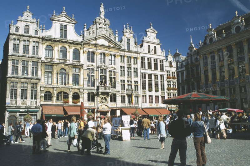 BELGIUM, Brussels, Grand Place lined with cafes with crowds of people and stalls.