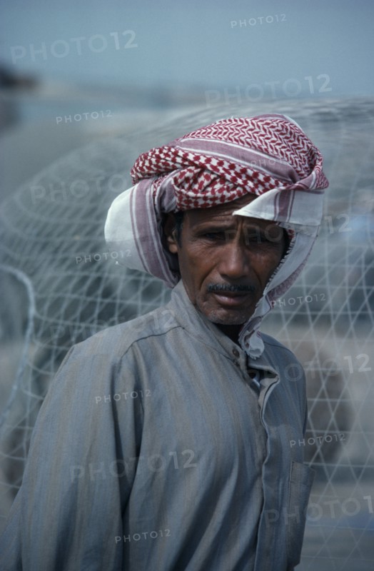 KUWAIT, People, Portrait of man wearing traditional red and white arab headscarf