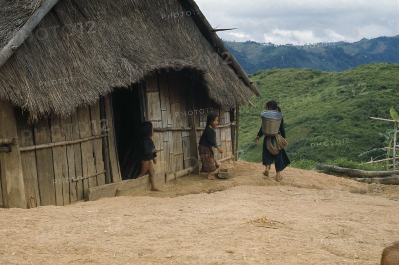 LAOS, Traditional Housing, Meo children outside thatched house in village near Luang Prabang.