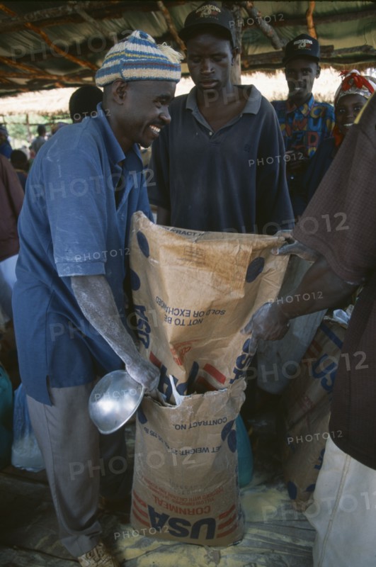 TANZANIA, West, Great Lakes Region, Mkugwa Refugee Camp.  Distribution of food aid supplying cornmeal from the United States of America.