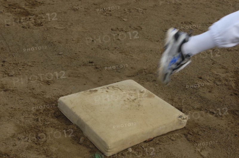 JAPAN, Chiba, Tako, Little league players foot rounds first base during practice at Toujou Shonen Yakyu baseball Club practice.
