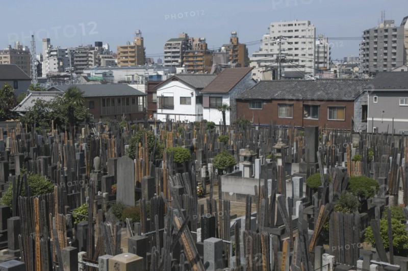 JAPAN, Honshu, Tokyo, Yanaka. View over the cemetary of Shoyomei-ji Temple closely surrounded by buildings