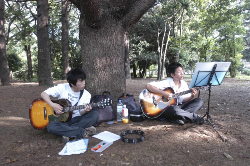 JAPAN, Honshu, Tokyo, "Yoyogi Park. Yuki Nakagawa and Yousuke Koyama, both 15 years old, meet here on Saturday afternoons to practice guitars and sing Harajuku"