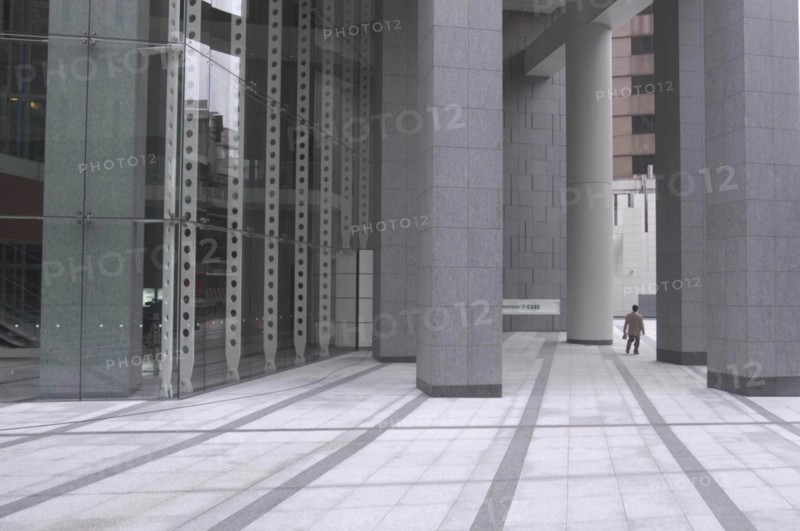 JAPAN, Honshu, Tokyo, "Roppongi ""Salariman"" officeworker crosses building plaza"