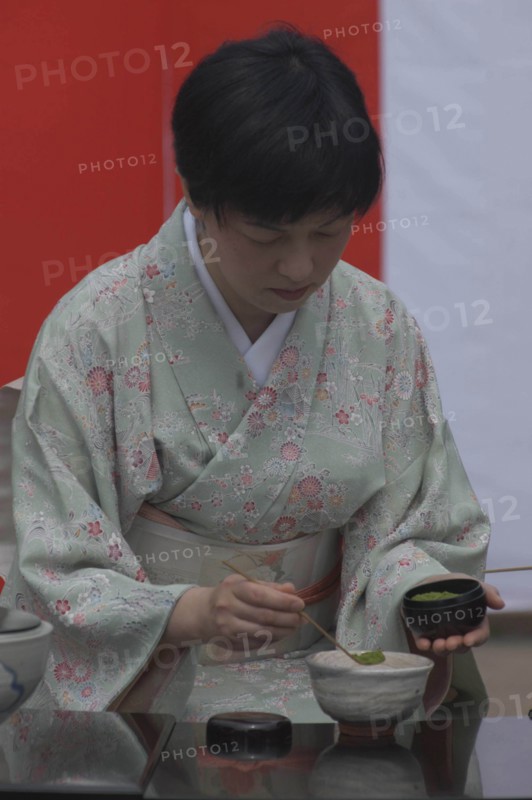 JAPAN, Chiba, Yokaichiba, "Licensed tea master, Chiharu Koshikawa, prepares green tea, ""macha"" at a tea ceremony and  places ""macha"" green tea powder in bowl"