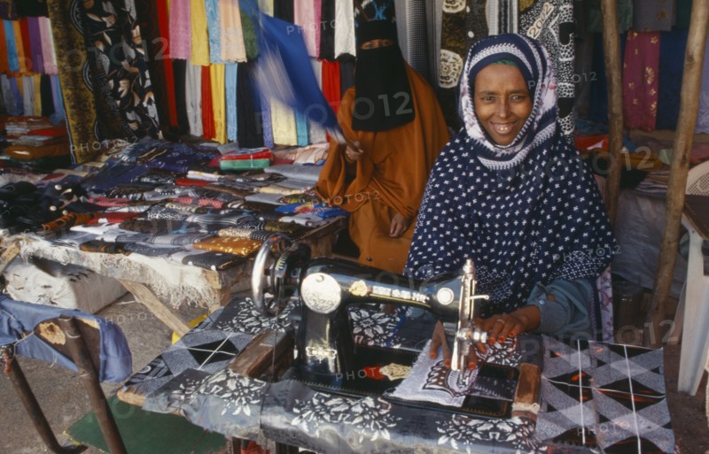 SOMALILAND, Hargeisa, Female trader at sewing machine in market.