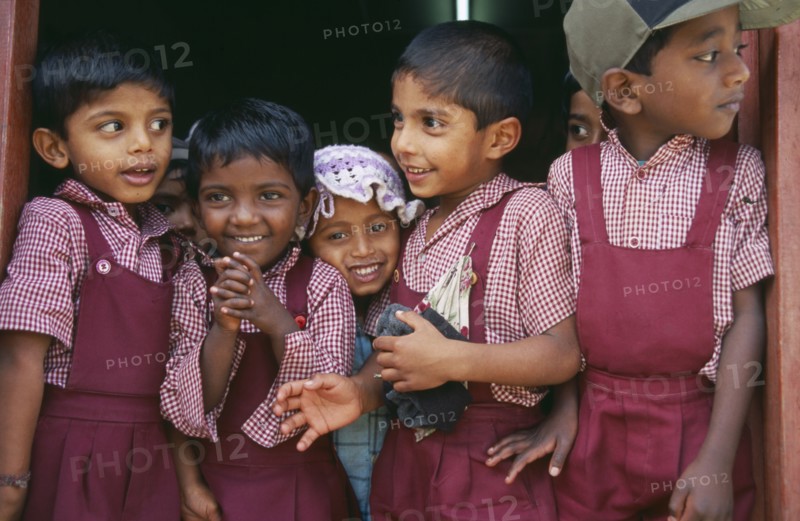 SRI LANKA, Dambetenne, Group of young school children wearing red uniform