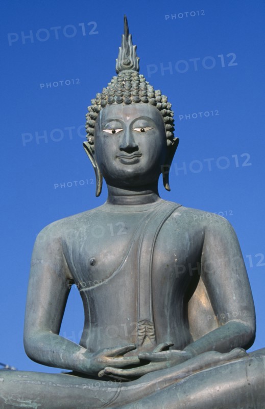 SRI LANKA, Colombo, Seema Malakaya on Beira Lake. Seated Buddha statue against a blue sky