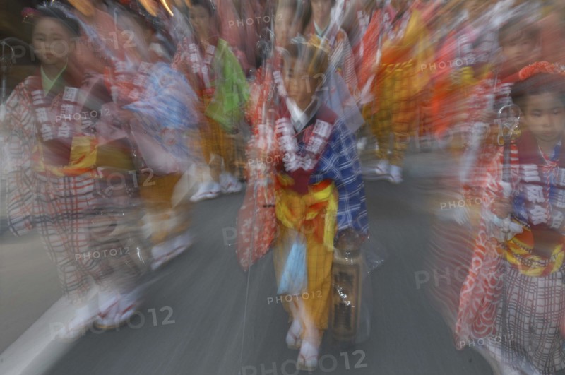 JAPAN, Chiba, Narita, "8 year old Maki Tsuchiya leads her neighborhood tekomae, girls that walk before the Dashi or wagon during Gion Matsuri wearing traditional Edo-era costume  Radial Blur."