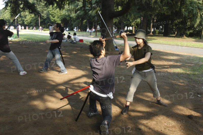 JAPAN, Honshu, Tokyo, "Harajuku. Yoyogi Park on Saturday afternoon, Miyuki Wada aged 31 and Takaki Hagi aged 20, practice sword fighting for Ichigaya Tanabata Festival"